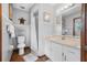 Bathroom featuring a shower, toilet, vanity with mirror, and neutral decor at 2249 Swoope Dr, New Smyrna Beach, FL 32168