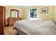 This bedroom features a double bed, a large mirror over a wood dresser, and a window at 2249 Swoope Dr, New Smyrna Beach, FL 32168
