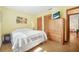 Bright bedroom with hardwood floors, closet, TV and beach-themed wall decor at 2249 Swoope Dr, New Smyrna Beach, FL 32168