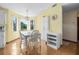 Sunny dining area with hardwood floors, chandelier, and large windows at 2249 Swoope Dr, New Smyrna Beach, FL 32168
