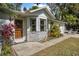 Welcoming single-story home with lush plants surrounding the entry, and an attached garage at 2249 Swoope Dr, New Smyrna Beach, FL 32168