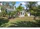 Charming single-story home featuring a brick facade, well-maintained lawn, and mature landscaping at 2249 Swoope Dr, New Smyrna Beach, FL 32168