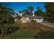 Charming single-story home with well-manicured lawn and tropical landscaping at 2249 Swoope Dr, New Smyrna Beach, FL 32168
