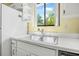 Bright kitchen with a stainless steel sink and a window with a view at 2249 Swoope Dr, New Smyrna Beach, FL 32168