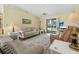 Comfortable living room with vaulted ceilings and sliding glass doors to the backyard at 2249 Swoope Dr, New Smyrna Beach, FL 32168