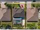 An aerial view showcasing a house with a pool and a red car in the driveway at 2344 Kelbrook Ct, Oviedo, FL 32765