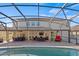 Spacious backyard with a pool, screened enclosure, covered patio, and ample seating for entertaining at 2344 Kelbrook Ct, Oviedo, FL 32765