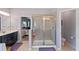 Bathroom featuring a glass-enclosed shower and access to the main bedroom at 2344 Kelbrook Ct, Oviedo, FL 32765