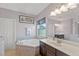 Bathroom with a large soaking tub, double vanity, and mosaic tile accents at 2344 Kelbrook Ct, Oviedo, FL 32765