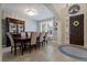 Formal dining area with a large window, elegant lighting, and seating for eight at 2344 Kelbrook Ct, Oviedo, FL 32765