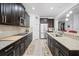 Sleek kitchen featuring stainless steel appliances, granite countertops, and dark wood cabinetry at 2344 Kelbrook Ct, Oviedo, FL 32765