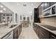 Modern kitchen featuring stainless steel appliances and dark cabinetry at 2344 Kelbrook Ct, Oviedo, FL 32765