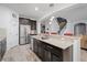 Spacious kitchen island with granite countertops, stainless steel appliances, and dark cabinetry for a modern feel at 2344 Kelbrook Ct, Oviedo, FL 32765