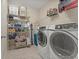 Well-equipped laundry room with modern washer and dryer, shelving, and ample storage space at 2344 Kelbrook Ct, Oviedo, FL 32765