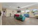 Open living room features modern furniture, hardwood floors, large windows, and a ceiling fan at 2344 Kelbrook Ct, Oviedo, FL 32765