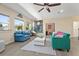 Cozy living room with comfortable furniture, hardwood floors, windows, and a decorative hanging chair at 2344 Kelbrook Ct, Oviedo, FL 32765