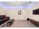 Spacious living room with a large screen television and wood-look flooring at 2344 Kelbrook Ct, Oviedo, FL 32765
