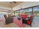 Relaxing screened-in patio with comfortable seating, ceiling fans, and views of the pool and backyard at 2344 Kelbrook Ct, Oviedo, FL 32765