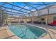 Sparkling pool surrounded by a screened enclosure, patio, and landscaping, creating a private oasis at 2344 Kelbrook Ct, Oviedo, FL 32765