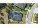 Aerial view of a home featuring a solar panel roof, screened-in pool and patio area within a fenced yard at 2393 Oxmoor Dr, Deland, FL 32724