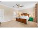 Bedroom featuring a neutral color scheme, wooden bed frame, a fan and two bedside tables at 2393 Oxmoor Dr, Deland, FL 32724