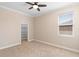 Cozy bedroom with neutral paint, carpeting, a ceiling fan and a walk-in closet at 2393 Oxmoor Dr, Deland, FL 32724
