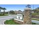 View of Bentley Green community sign surrounded by plants and palm trees at 2393 Oxmoor Dr, Deland, FL 32724
