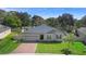 Well-maintained home with brick driveway and manicured lawn at 2393 Oxmoor Dr, Deland, FL 32724