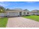 Attractive home with a brick driveway, attached garage, and well-kept lawn at 2393 Oxmoor Dr, Deland, FL 32724
