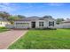 Charming single-story home with brick driveway and well-manicured lawn at 2393 Oxmoor Dr, Deland, FL 32724