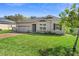 Beautiful home with a lush green lawn, brick driveway, and lovely landscaping at 2393 Oxmoor Dr, Deland, FL 32724