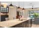 Kitchen island featuring granite countertop, sink, stainless steel dishwasher, and seating at 2393 Oxmoor Dr, Deland, FL 32724