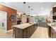 Open concept kitchen with large island, wood floors, and view of the backyard at 2393 Oxmoor Dr, Deland, FL 32724