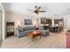 Living room featuring wood floors, sectional sofa, and open access to the kitchen at 2393 Oxmoor Dr, Deland, FL 32724