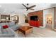 Open-concept living room with wood floors, red cabinet, and view to the kitchen at 2393 Oxmoor Dr, Deland, FL 32724