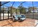 Screened-in lanai with ample seating and brick pavers at 2393 Oxmoor Dr, Deland, FL 32724