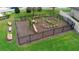 Aerial view of a community playground with a variety of play structures and benches within a fenced area at 2393 Oxmoor Dr, Deland, FL 32724