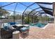 Screened-in pool area with patio furniture and brick pavers at 2393 Oxmoor Dr, Deland, FL 32724