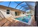 In-ground pool featuring brick deck with a screened enclosure at 2393 Oxmoor Dr, Deland, FL 32724