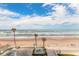 Scenic ocean view featuring a beach, palm trees, and architectural details at 2700 N Atlantic Ave # 454, Daytona Beach, FL 32118