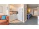 Compact kitchen with white cabinets, modern appliances, and a view into the bedroom at 2700 N Atlantic Ave # 454, Daytona Beach, FL 32118