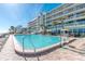 Resort-style outdoor pool with a lifeguard stand, surrounded by lounge chairs and palm trees at 2700 N Atlantic Ave # 454, Daytona Beach, FL 32118