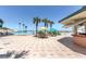 Resort-style pool area with tables and chairs beneath umbrellas, adjacent to a poolside bar and the ocean at 2700 N Atlantic Ave # 454, Daytona Beach, FL 32118