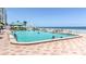 Outdoor swimming pool with beautiful ocean views, lounge chairs, and a lifeguard stand at 2700 N Atlantic Ave # 454, Daytona Beach, FL 32118