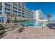 Outdoor pool area with plenty of lounge chairs for sunbathing at 2700 N Atlantic Ave # 454, Daytona Beach, FL 32118