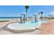 Inviting splash pad area with water features, palm trees, and the ocean in the background, perfect for Gathering fun at 2700 N Atlantic Ave # 454, Daytona Beach, FL 32118