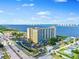Stunning aerial view of a waterfront condo building offering beautiful views of the water and city skyline at 2801 S Ridgewood Ave # 1214, South Daytona, FL 32119