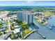 Aerial view of building complex featuring pool, landscaping, waterways, and surrounding area at 2801 S Ridgewood Ave # 1214, South Daytona, FL 32119