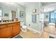 Bathroom featuring a granite countertop vanity, toilet and view into the bedroom beyond at 2801 S Ridgewood Ave # 1214, South Daytona, FL 32119