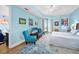 Relaxing bedroom featuring blue walls, light wood floors, and a private balcony at 2801 S Ridgewood Ave # 1214, South Daytona, FL 32119